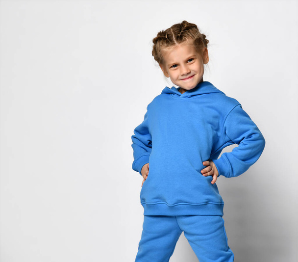 Young baby kid in blue hoodie with free text copy space happy smiling on white background - Valokuva, kuva