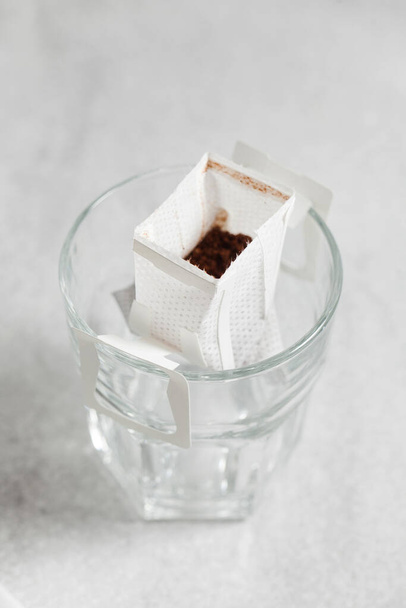 Drip coffee bag in a mug. Trends in brewing coffee at home. - Foto, Bild