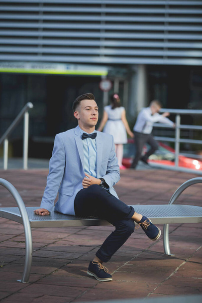 A young elegant Caucasian man wearing an expensive blue suit at an event - Fotografie, Obrázek