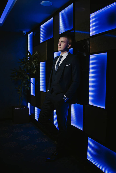 A vertical shot of a handsome Bosnian Caucasian man wearing a suit, posing indoors - Photo, Image