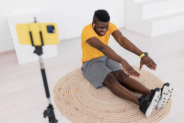 african american man  exercising  and taking video - 写真・画像