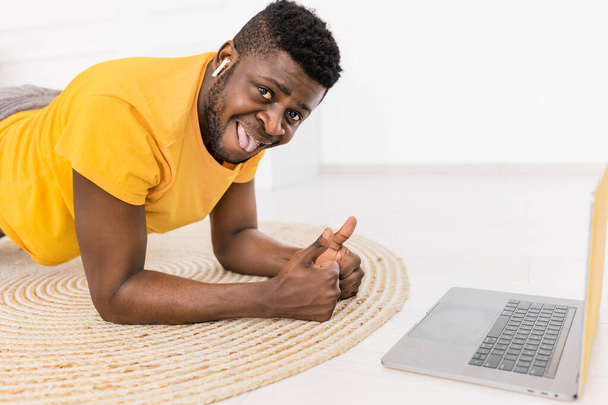 african american man with laptop showing thumbs up  - Valokuva, kuva