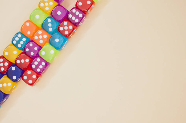 Colorful dice in a row isolated on a beige background - Foto, immagini