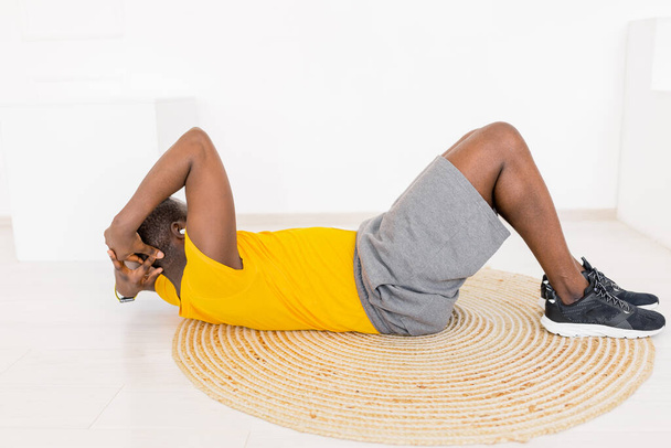 young man exercising  on the floor at home  - Photo, image