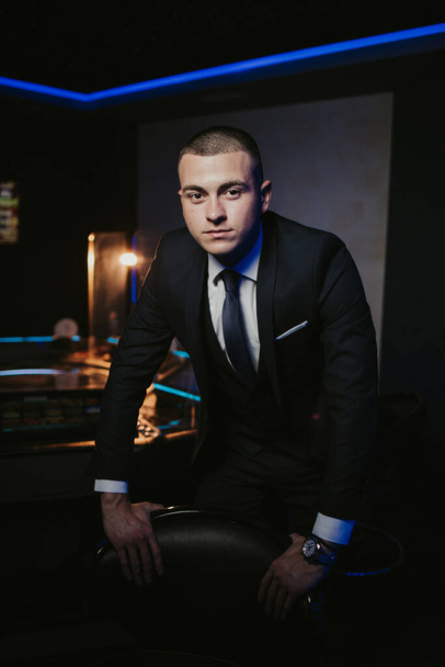 A caucasian businessman on dark background - Photo, Image