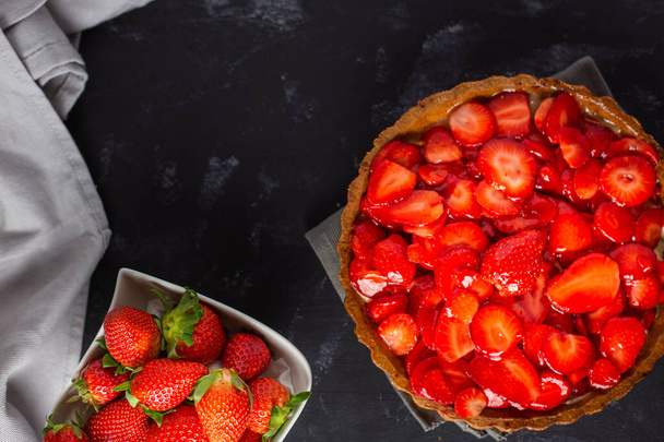 A closeup shot of delicious strawberry tart on black background - Fotoğraf, Görsel