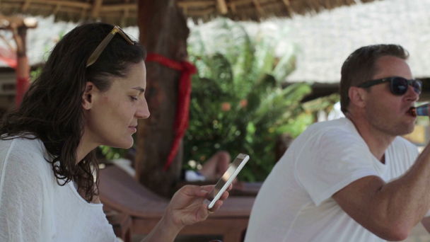 Woman with smartphone and boyfriend - Materiał filmowy, wideo