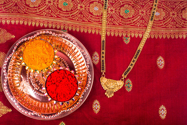 Indian Festival: Rakhi with kumkum, sweets and diya on plate with an elegant Rakhi. A traditional Indian wrist band which is a symbol of love between Brothers and Sisters - Photo, Image