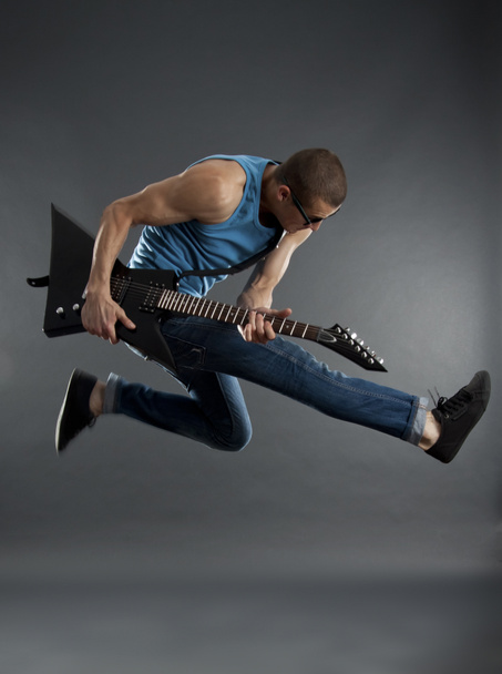 Rock star jumping with guitar - Photo, Image