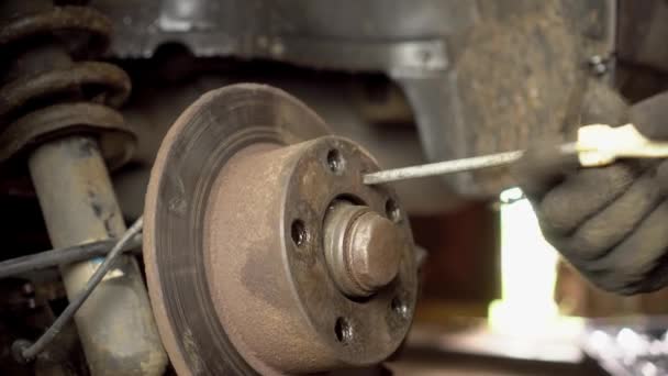 The hands of a master or car mechanic repair the brakes in the car. - Footage, Video