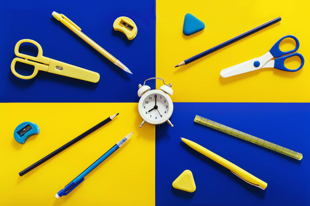Flat lay with stationery and school items with bright yellow and blue colors. Back to school creative concept, morning time. - Foto, immagini