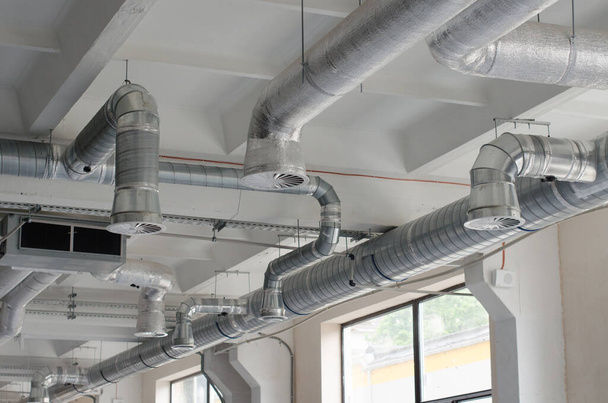 System of industrial ventilating pipes. Air conditioning of buildings. Background of ventilation pipes. Laying of engineering networks. - Photo, Image