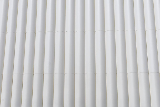 circular metal structure made of several white tubes as a cladding for an outer wall of an external wall construction background concept - Foto, Imagem
