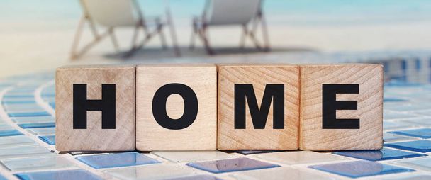 Wooden cubes with the word home, home on a wooden background. Emigration consept. - Photo, Image