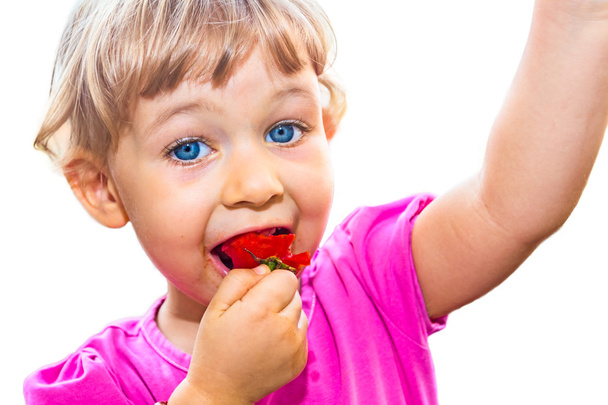 Little girl eating tomato - Photo, Image