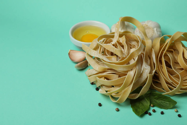Concept of cooking tasty pasta on mint background - Photo, Image