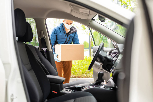 Delivery driver driving with parcels on seat - Photo, Image