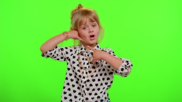 Funny playful child girl looking at camera doing phone gesture like says hey you call me back - Footage, Video