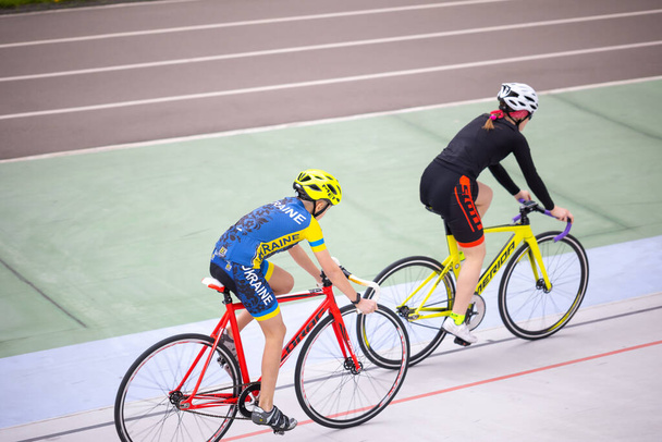Kyiv, Ukraine - 2021 May 15: Training in the discipline of Keirin(track cycling race) on the Kyiv Cycle Track under the guidance of coach, multiple champion of Ukraine and the USSR Eugene Prysyazhenko - Zdjęcie, obraz
