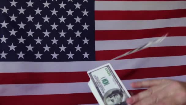Falling dollars on the background of the American flag .In slow motion. Money rain. - Footage, Video