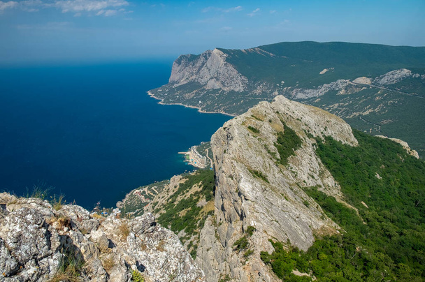 Mediterranean landscape. Forested rocks of the Black Sea coast of the southern coast of the Crimean Peninsula on a clear sunny day. - Фото, зображення