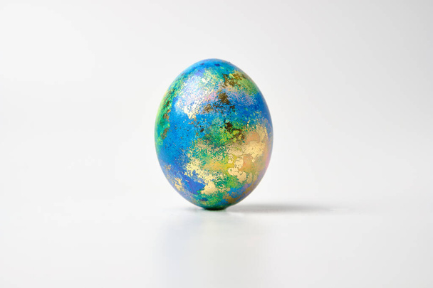 Easter eggs. Easter background. Easter. Copy cpase egg isolated on a white background painted like planet earth, a workpiece for the designer. - Фото, зображення