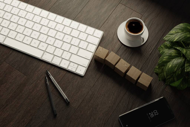 Trabajo desde casa. escritorio con teclado, cubos de madera en blanco, taza de café y pluma en la mesa de madera. Vista superior plana - Foto, Imagen