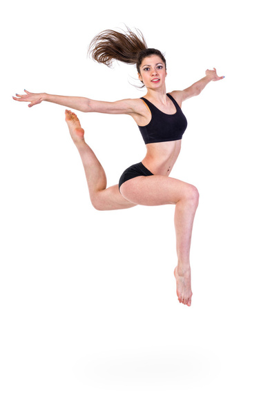 pretty modern slim girl jumping dancing isolated on a white background - Foto, Bild
