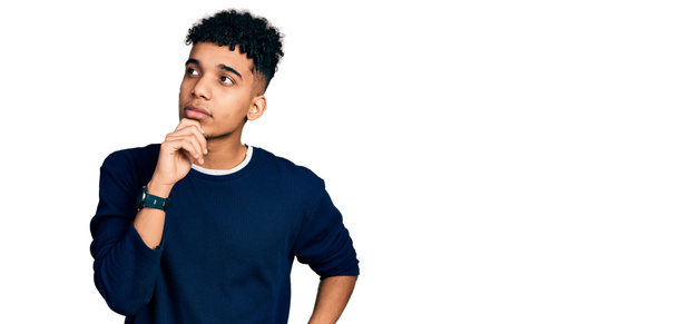 Young african american man wearing casual clothes with hand on chin thinking about question, pensive expression. smiling with thoughtful face. doubt concept.  - Photo, Image
