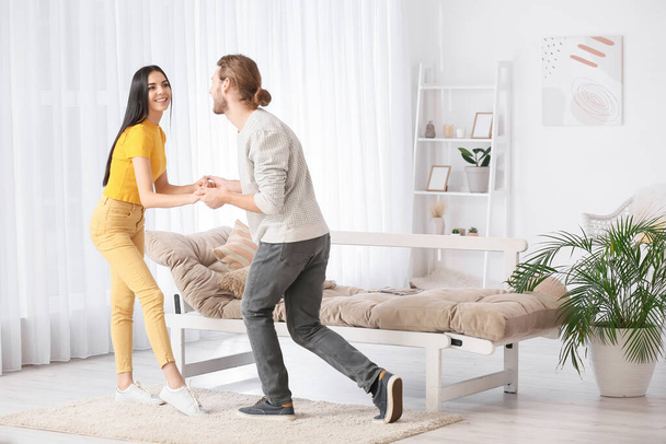 Happy young couple dancing at home - Foto, Imagem
