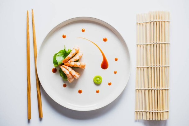 A top view of delicious Japanese shrimps with wasabi and soy sauce on the table - 写真・画像