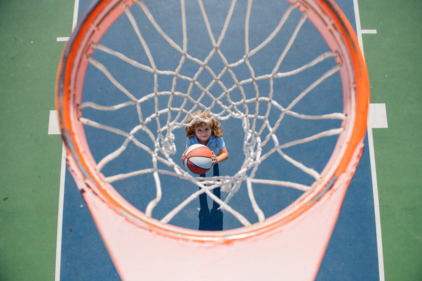 Top view of kid playing basketball with basketball ball. - Φωτογραφία, εικόνα
