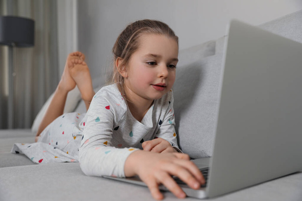 Little girl learning English indoors at online lesson - Foto, immagini