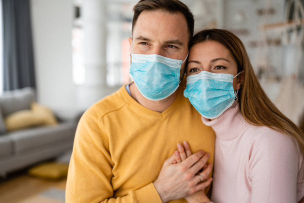 Pandemic coronavirus couple home isolation auto quarantine wearing face mask protective for spreading of disease virus - Photo, image