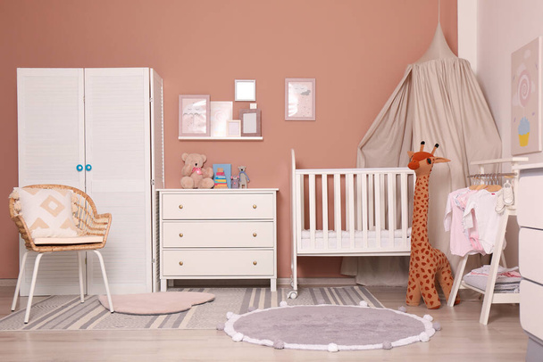 Baby room interior with stylish furniture and comfortable crib - Fotó, kép