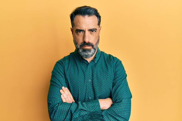 Middle age man with beard and grey hair wearing business clothes skeptic and nervous, disapproving expression on face with crossed arms. negative person.  - Foto, immagini