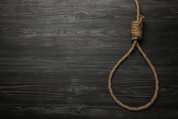 Rope noose on black wooden table, top view. Space for text - Photo, Image