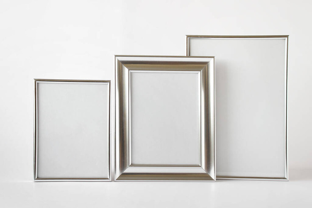 Mockup template with set of three silver glossy metallic frames with blank space on white background. - Fotoğraf, Görsel