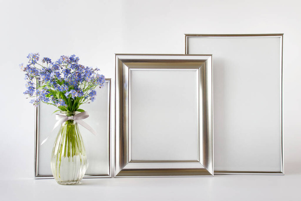 Composition with three mockup templates silver frames and blue flowers. - Foto, immagini