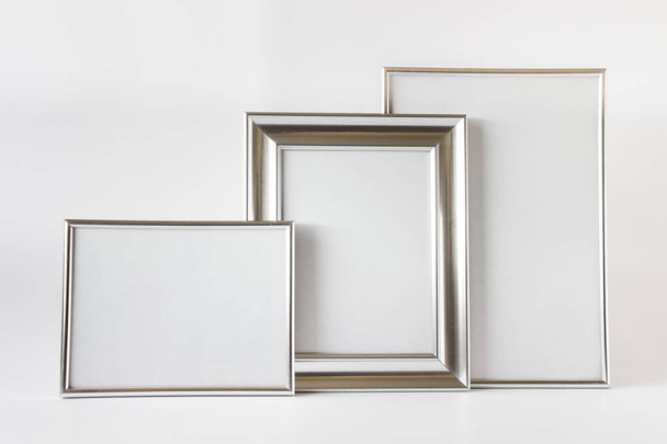 Composition with three silver framed canvas with blank space on white background. - Фото, изображение