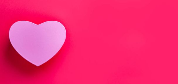 A heart-shaped gift isolated on a pink background with free space for text- mother's day concept - Foto, Bild