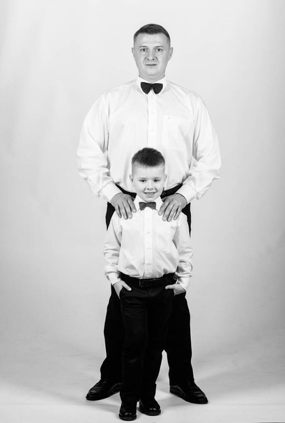 Father and son formal clothes outfit. Formal event. Grow up gentleman. Gentleman upbringing. Little son following fathers example of noble man. Gentleman upbringing. Visit theatre dress code - Photo, image