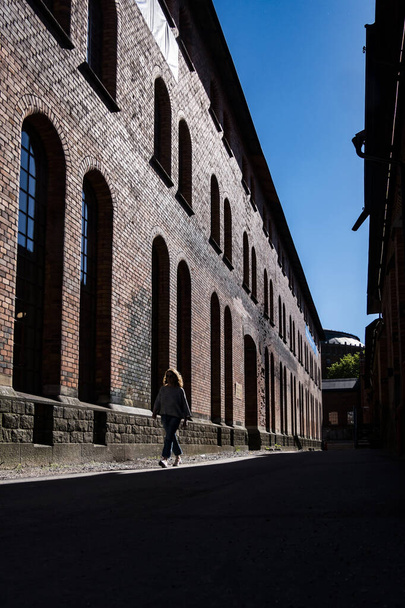 Stockholm, Svédország Egy személy keringőzik egy régi ipari komplexumban Norra Djurgardstaden szomszédságában. - Fotó, kép