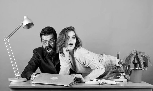 corporate ethics. businessman and assistant. business couple at computer. love affair at work. Seduction. woman and man work in office at laptop. secretary with boss at workplace. We are the winners - 写真・画像