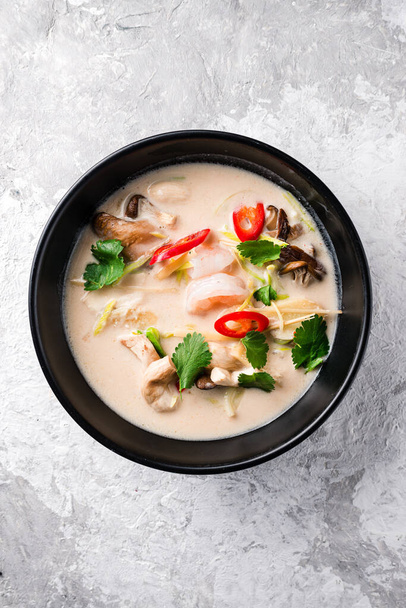 Tom kha with shrimp. Traditional thai soup Tom Kha coconut milk with shrimp. Traditional Thai Coconut soup. Asian Seafood soup top view, flat lay - Valokuva, kuva
