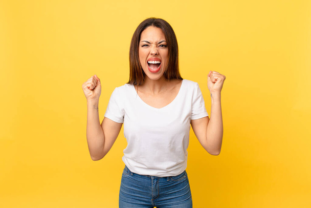 young hispanic woman shouting aggressively with an angry expression - Photo, Image