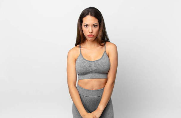young hispanic woman feeling sad and whiney with an unhappy look and crying. fitness concept - Photo, image