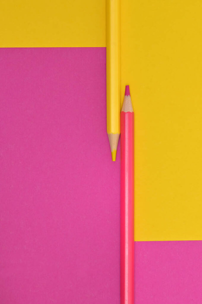 Abstract yellow and pink crayons on the same paper background - Fotografie, Obrázek