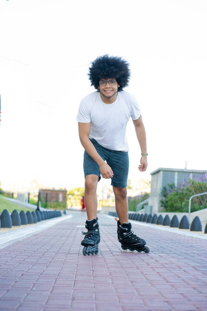 Latin man rollerskating outdoors on the street. - Foto, Imagen