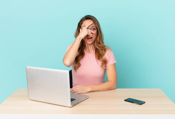 pretty woman looking shocked, scared or terrified, covering face with hand. telework concept - Photo, Image